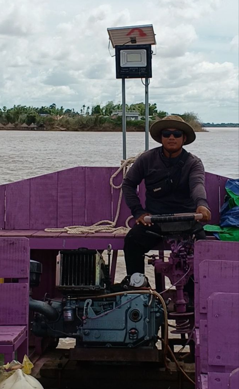 Founder Phonh driving the tour boat at Dream Garden.
