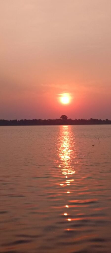 Golden sunset reflecting over the Mekong River water.