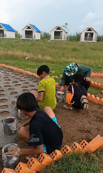 Using recycled paint buckets as molds for concrete garden borders.