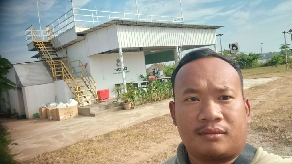 Dream Garden owner Phonh standing in front of the MOKO café building, showcasing the new brand identity.