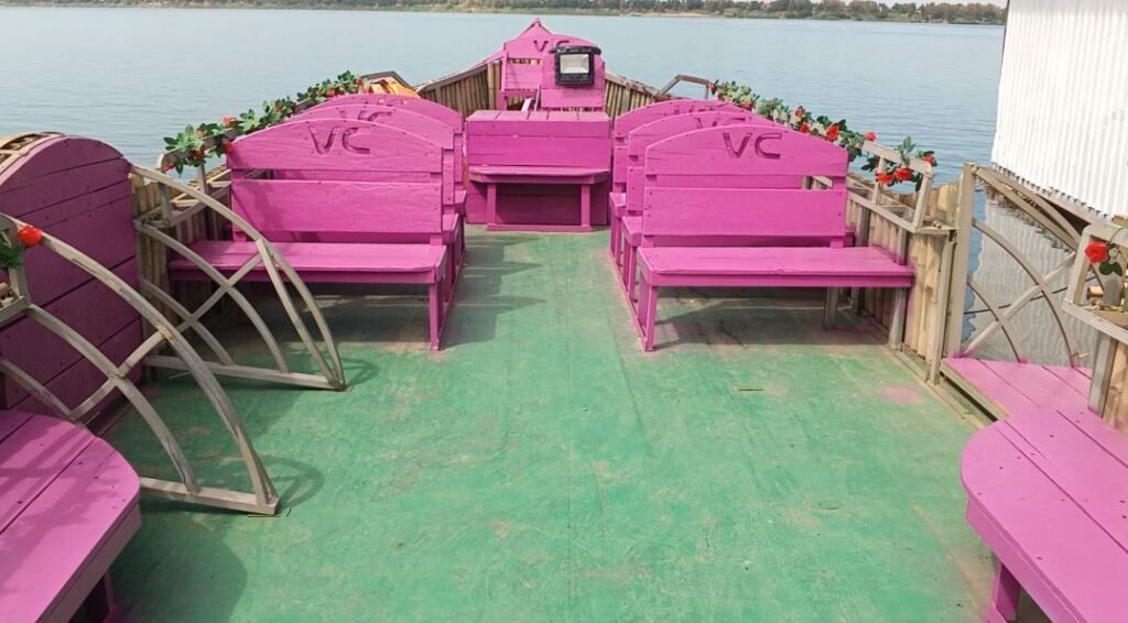 Interior view of the wooden boat painted bright pink with floral decorations to create a unique customer experience.