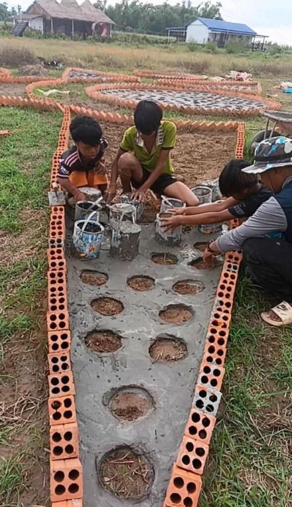 Pouring cement into a star-shaped garden border using brick walls and bucket molds.