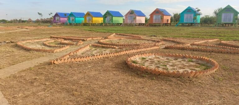 Dream Garden owner Phonh standing in front of the brick layout for a DIY star-shaped garden project.