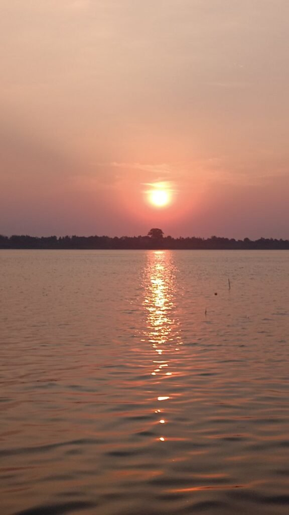 Peaceful orange sunset view from Dream Garden, symbolizing reflection after a difficult business collapse.