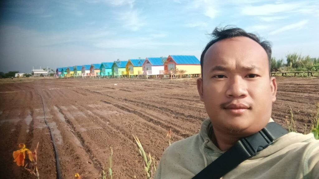 The start of the project at Dream Garden. You can see our signature colorful cabins in the background, but in front of them, it was just rows of empty, plowed earth waiting for life.